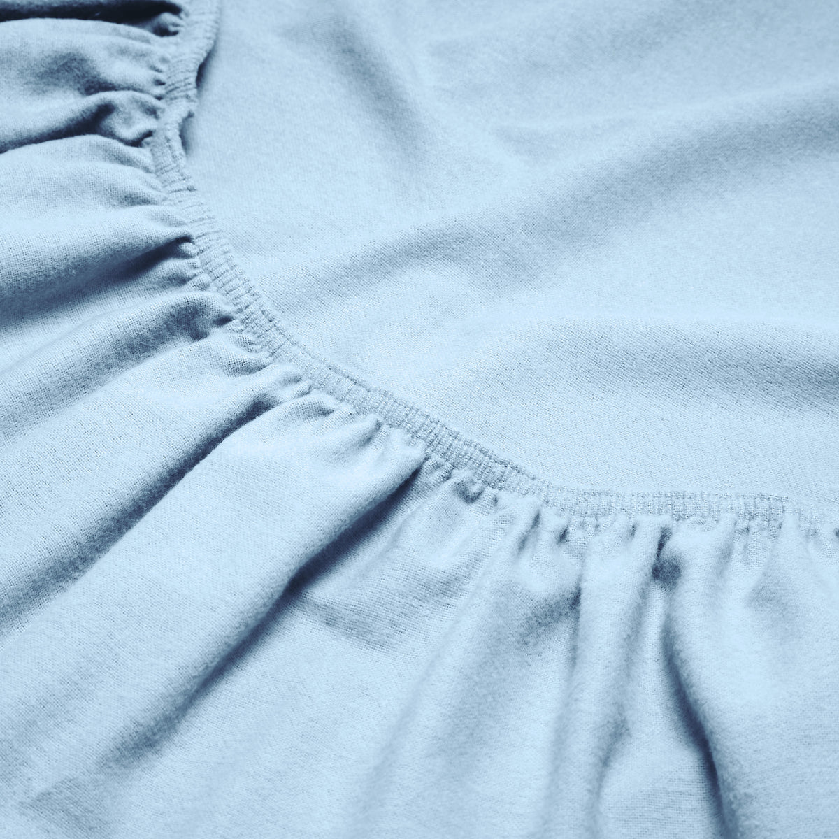 Close-up of a flannel fitted sheet with gathered elastic