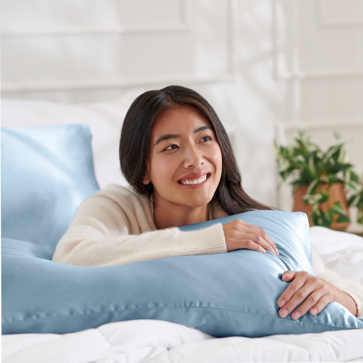 Woman lying on abed with a silk pillowcase