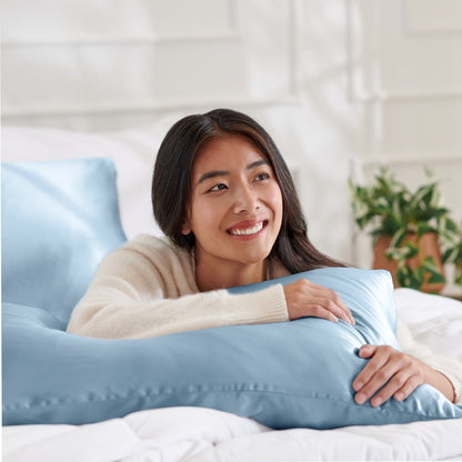 Woman lying on abed with a silk pillowcase