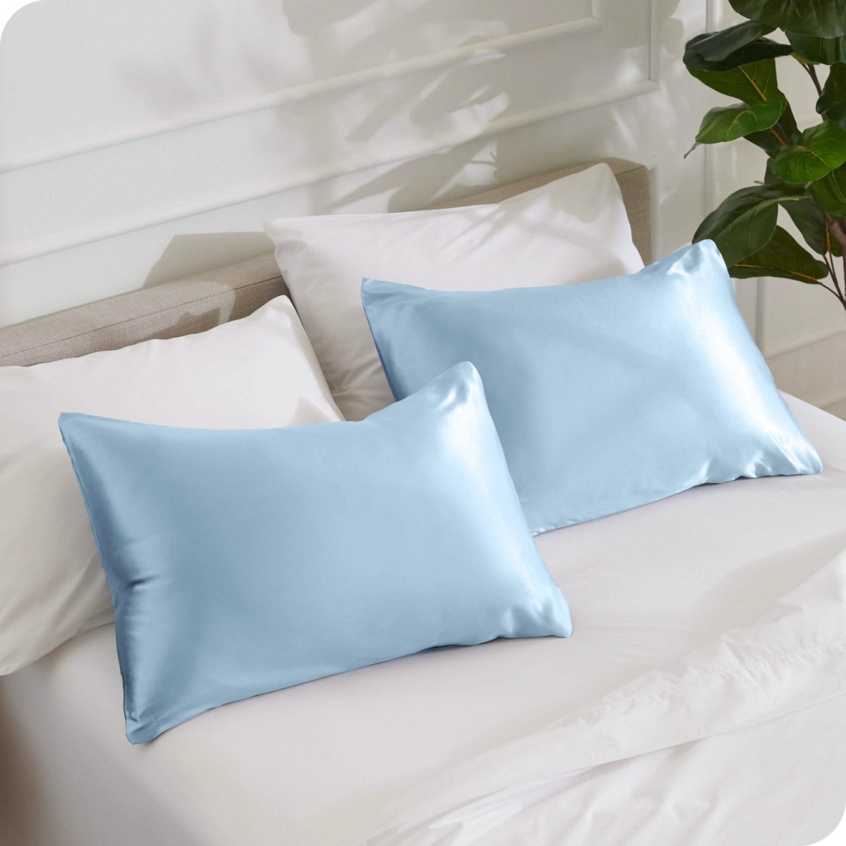 2 mulberry silk pillowcases on pillows set on a bed