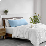 A body pillowcase on a pillow on a bed in a modern bedroom