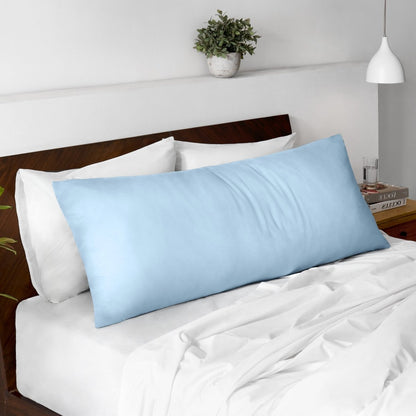 Body pillow on a bed with a wooden headboard and minimal decor.
