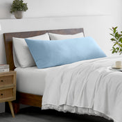 Bed with microfiber bedding and wooden headboard in a bedroom setting