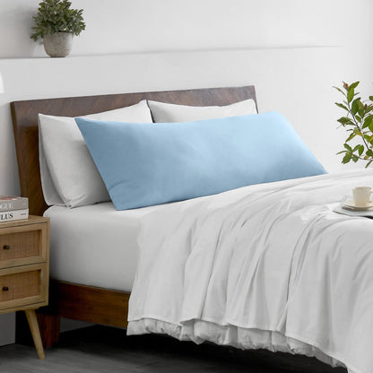 Bed with microfiber bedding and wooden headboard in a bedroom setting
