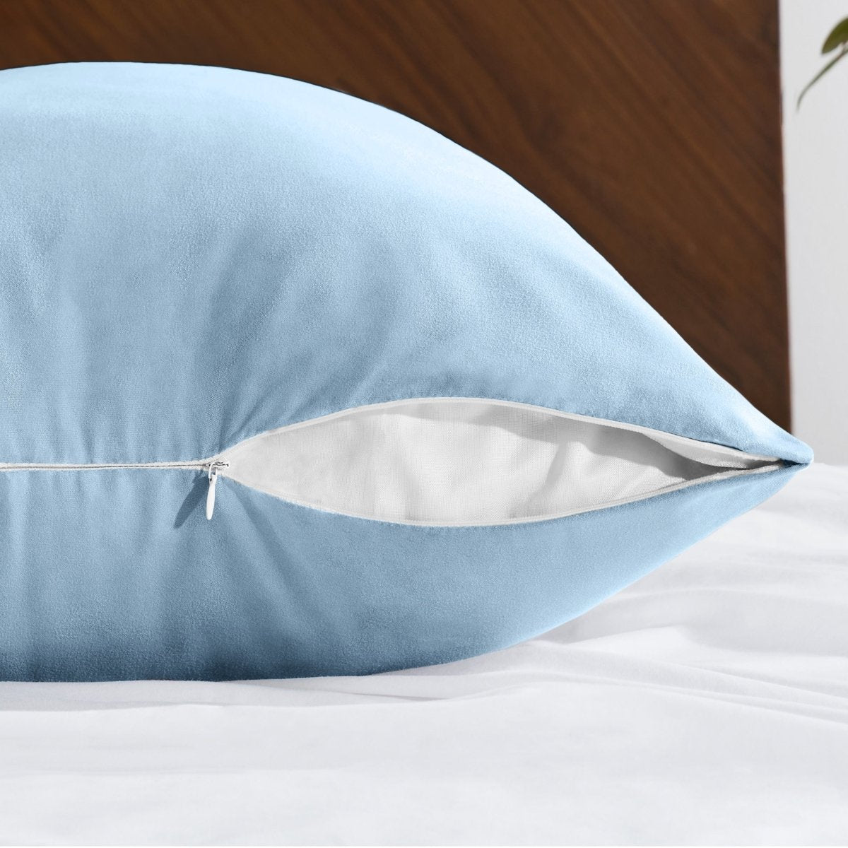 Body pillowcase with a zipper closure on a bed with a wooden headboard