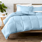 A modern bed with a down alternative comforter set on it