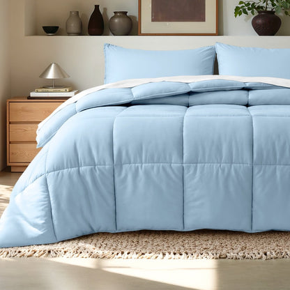 Comforter on a bed in a bedroom setting with a wooden nightstand and decorative items.