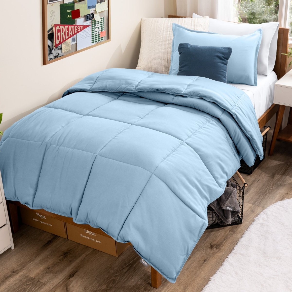 Bed with comforter and pillows in a dorm room