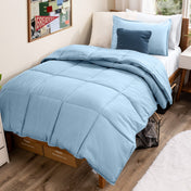 Bed with comforter and pillows in a dorm room