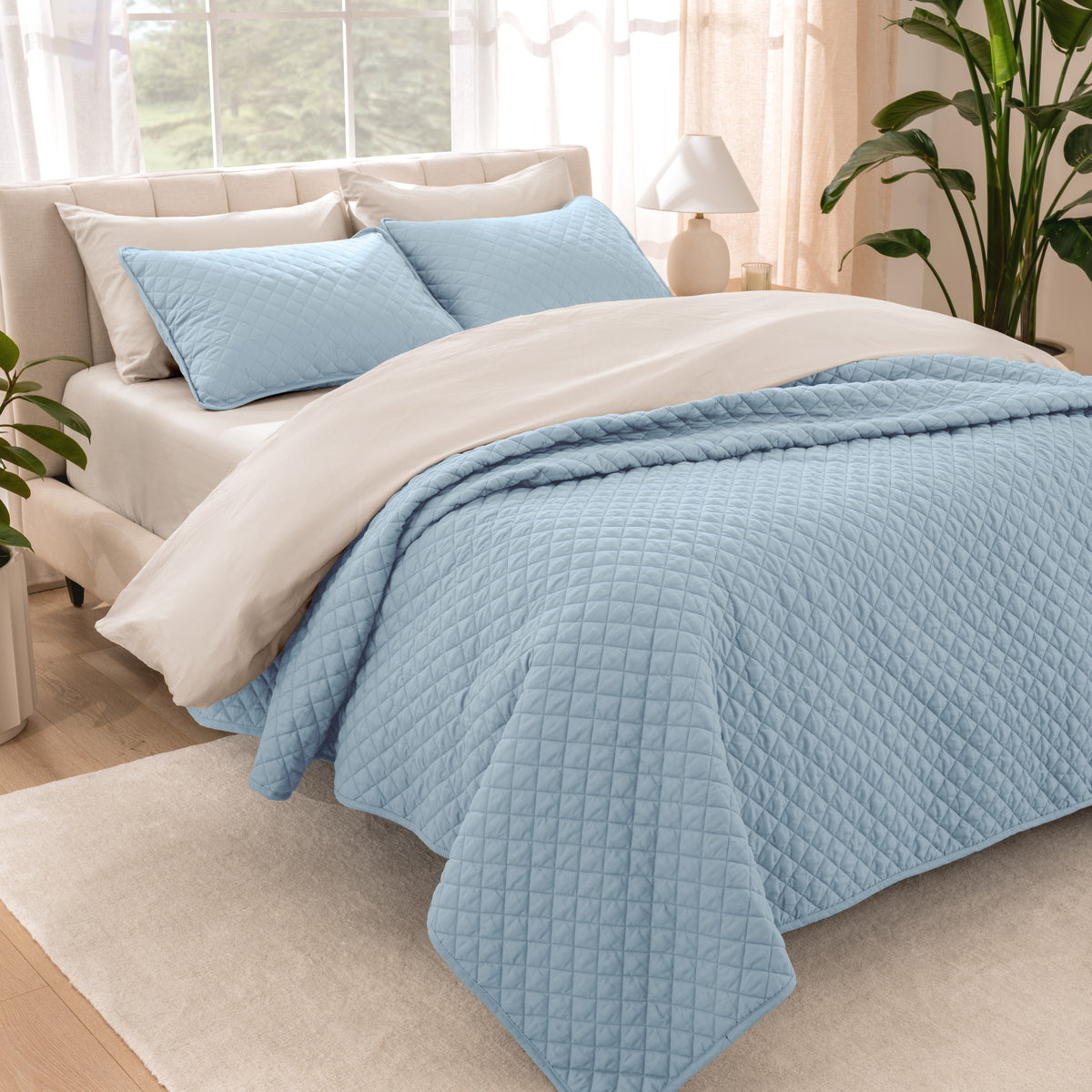 Bedroom showing coverlet set laying on the bed with the quilt folded over on itself