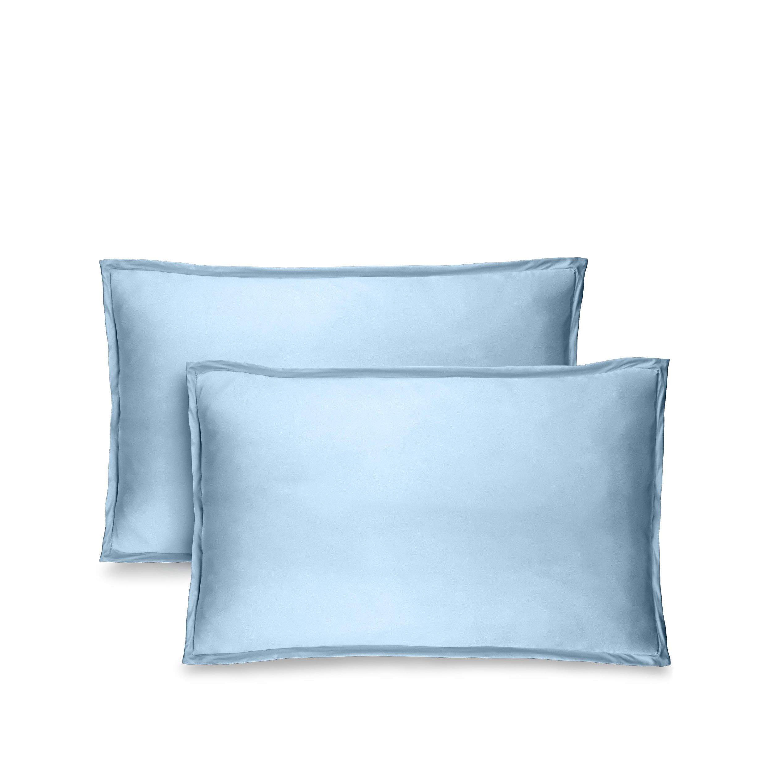 Two blue pillow shams on pillows standing up with one behind the other