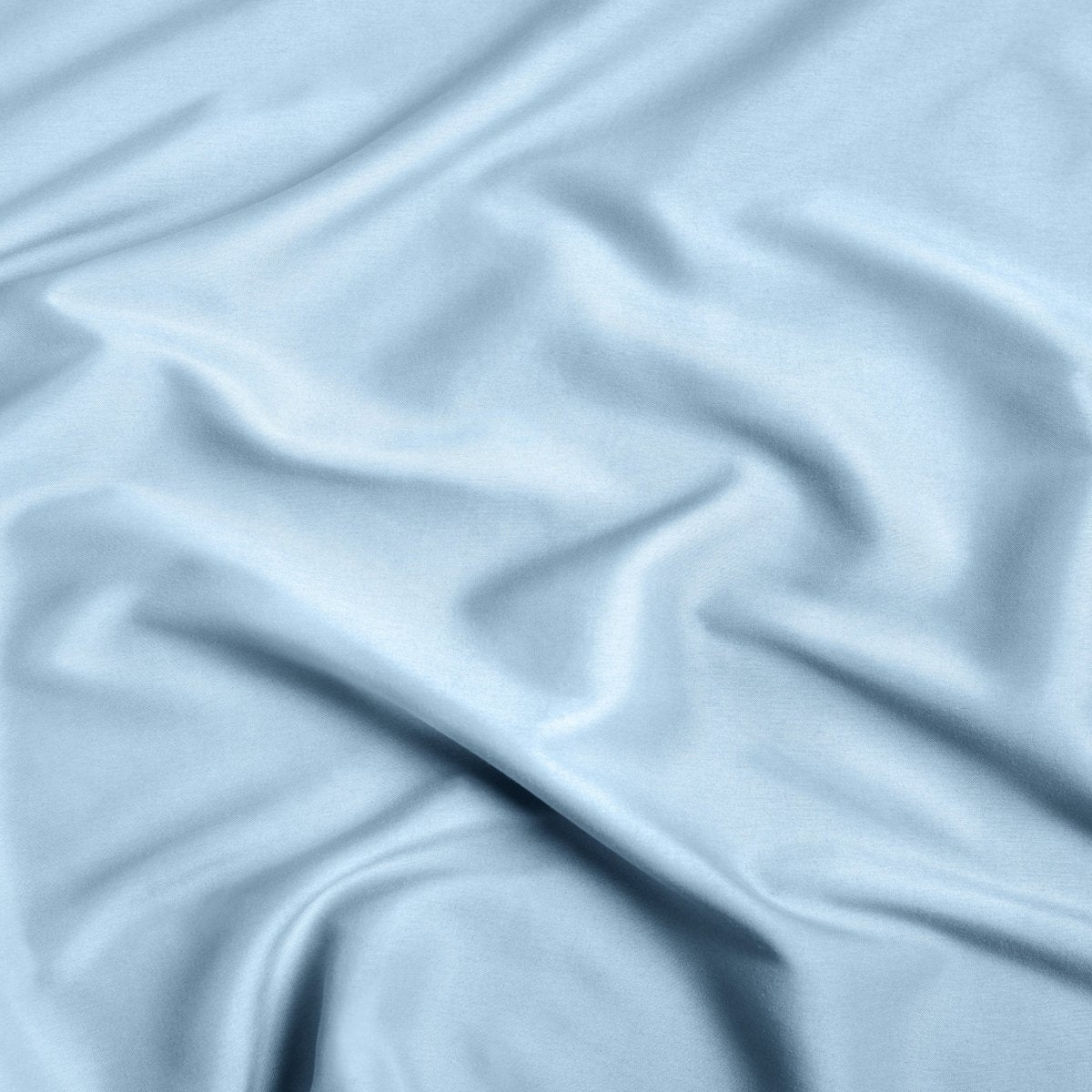 A close-up of ultra soft sheet fabric with soft folds and a smooth texture