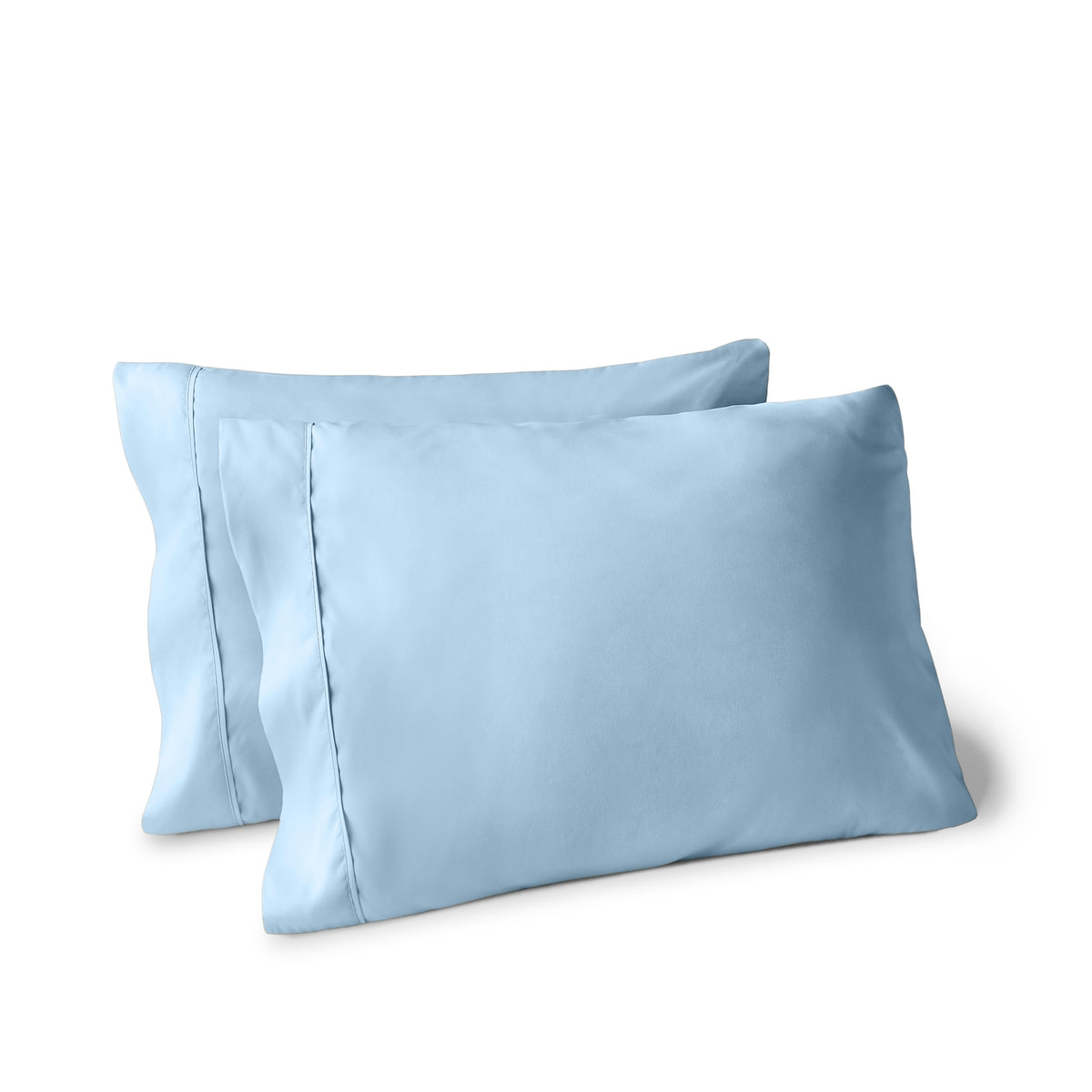 Two pillows on a white background with pillowcases on them