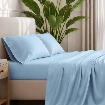 Ultra-soft sheets and pillowcases on a bed with a plant in the background