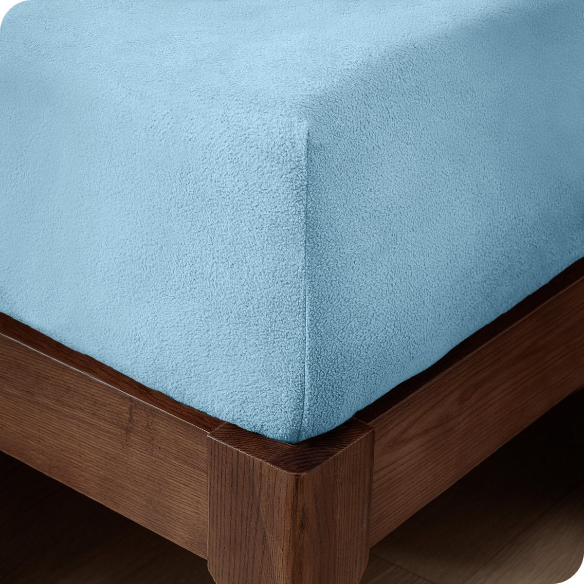 Close up of the corner of a mattress with a fleece fitted sheet on it