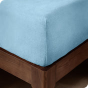 Close up of the corner of a mattress with a fleece fitted sheet on it