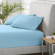 A sideview of a modern bed with a polar fleece fitted sheet on.