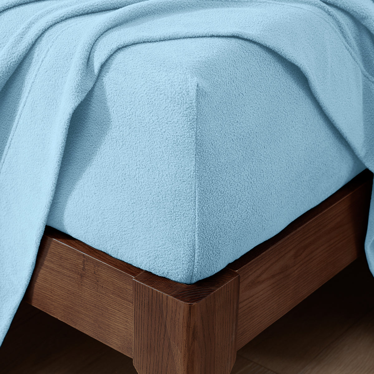 Fitted sheet on a wooden bed frame