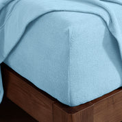 Corner of a mattress with a fitted sheet on it
