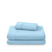 Polar fleece sheets and pillowcases folded and stacked on a white background