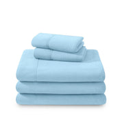 Polar fleece sheets and pillowcases folded and stacked on a white background