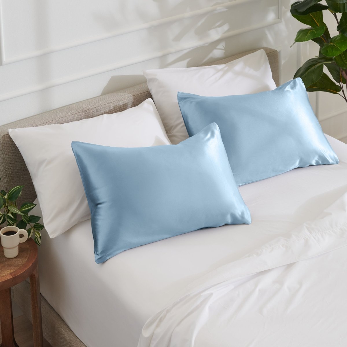 Satin pillowcases on a bed with white bedding