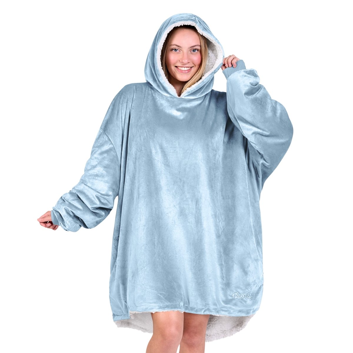 An adult with a sherpa wearable blanket on
