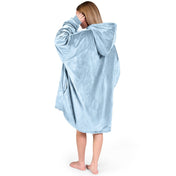 An adult with a hooded wearable blanket on