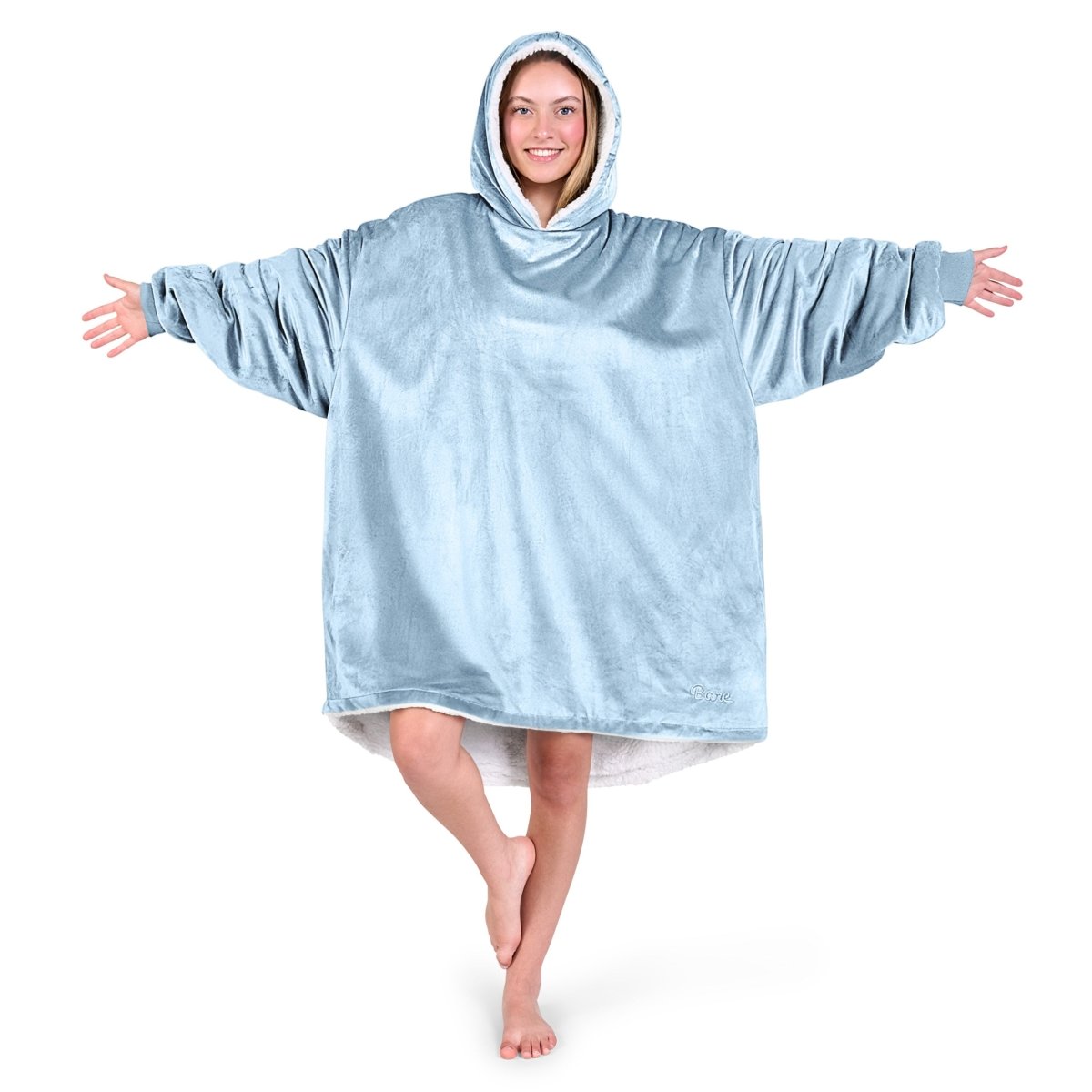 An adult with a sherpa wearable blanket on