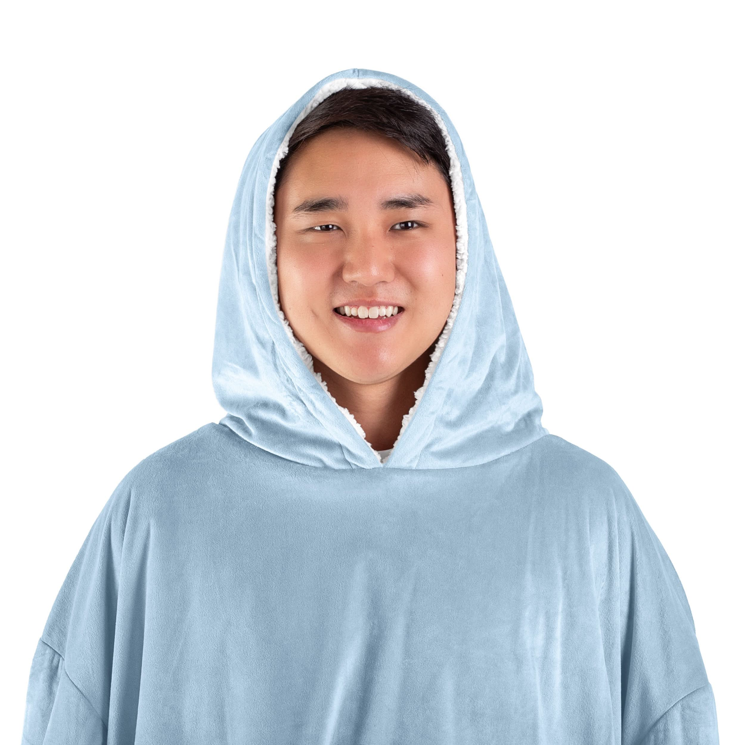 A man has a wearable blanket with the hood on