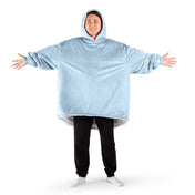 An adult with a sherpa wearable blanket on