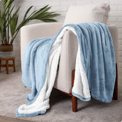 Blanket draped over a chair in a cozy living room setting.