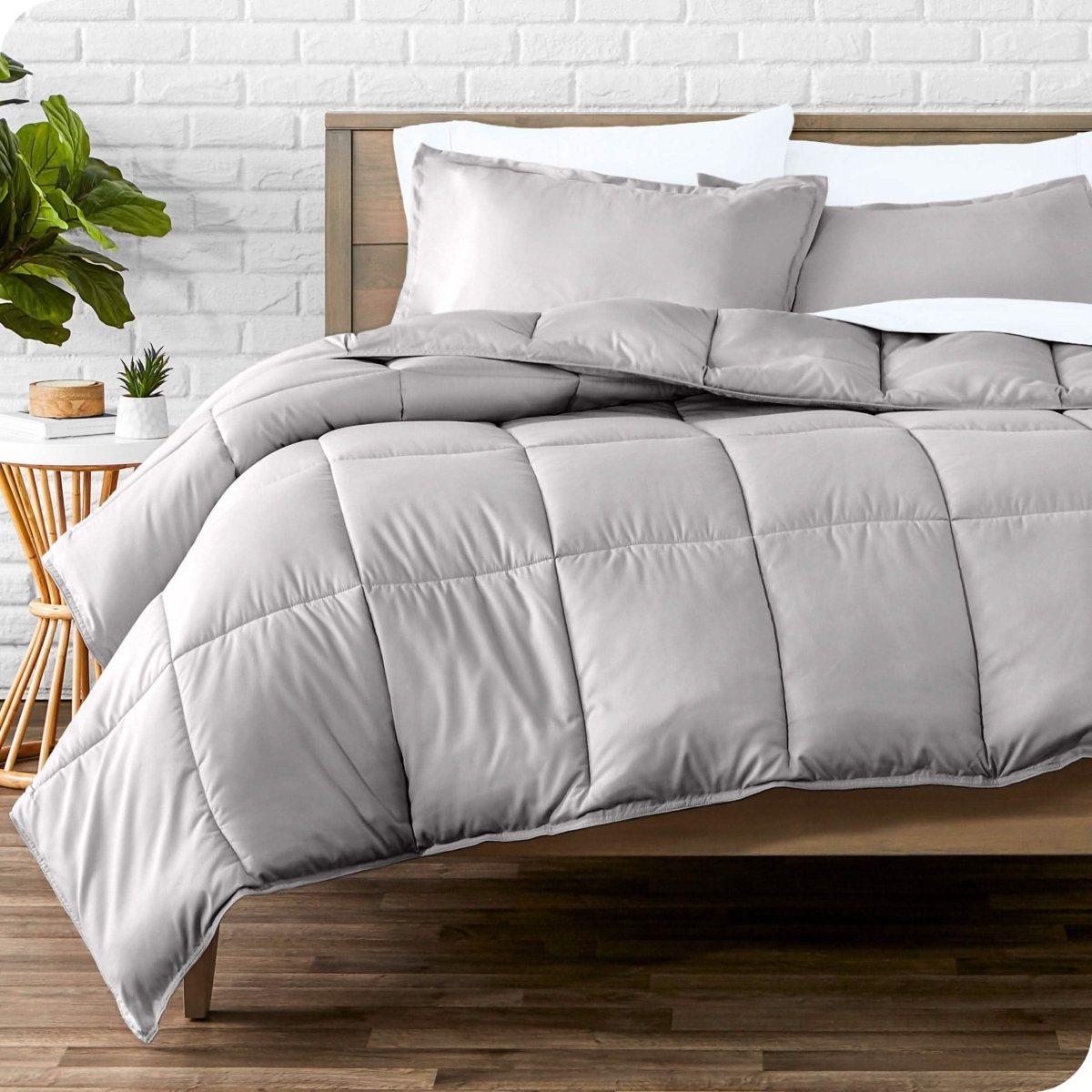 A modern bedroom with microfiber sheets and a comforter on the bed