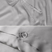 Close-up of the corner ties and button closure on a duvet cover