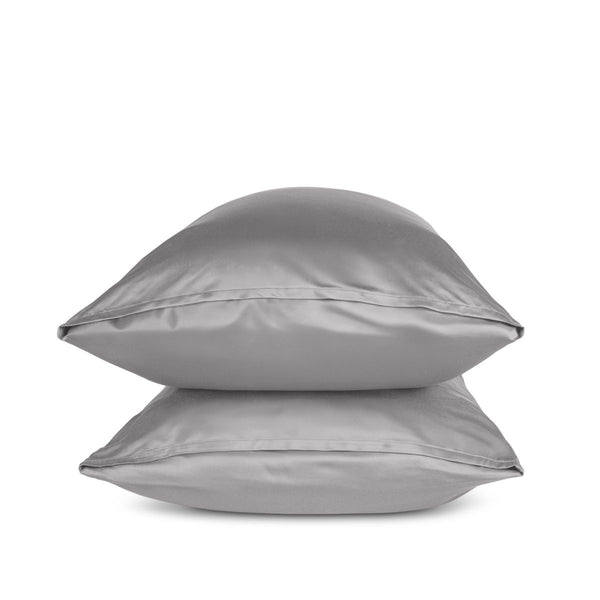 Two grey pillows stacked on a white background