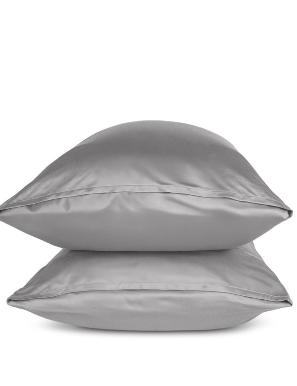 Two grey pillows stacked on a white background