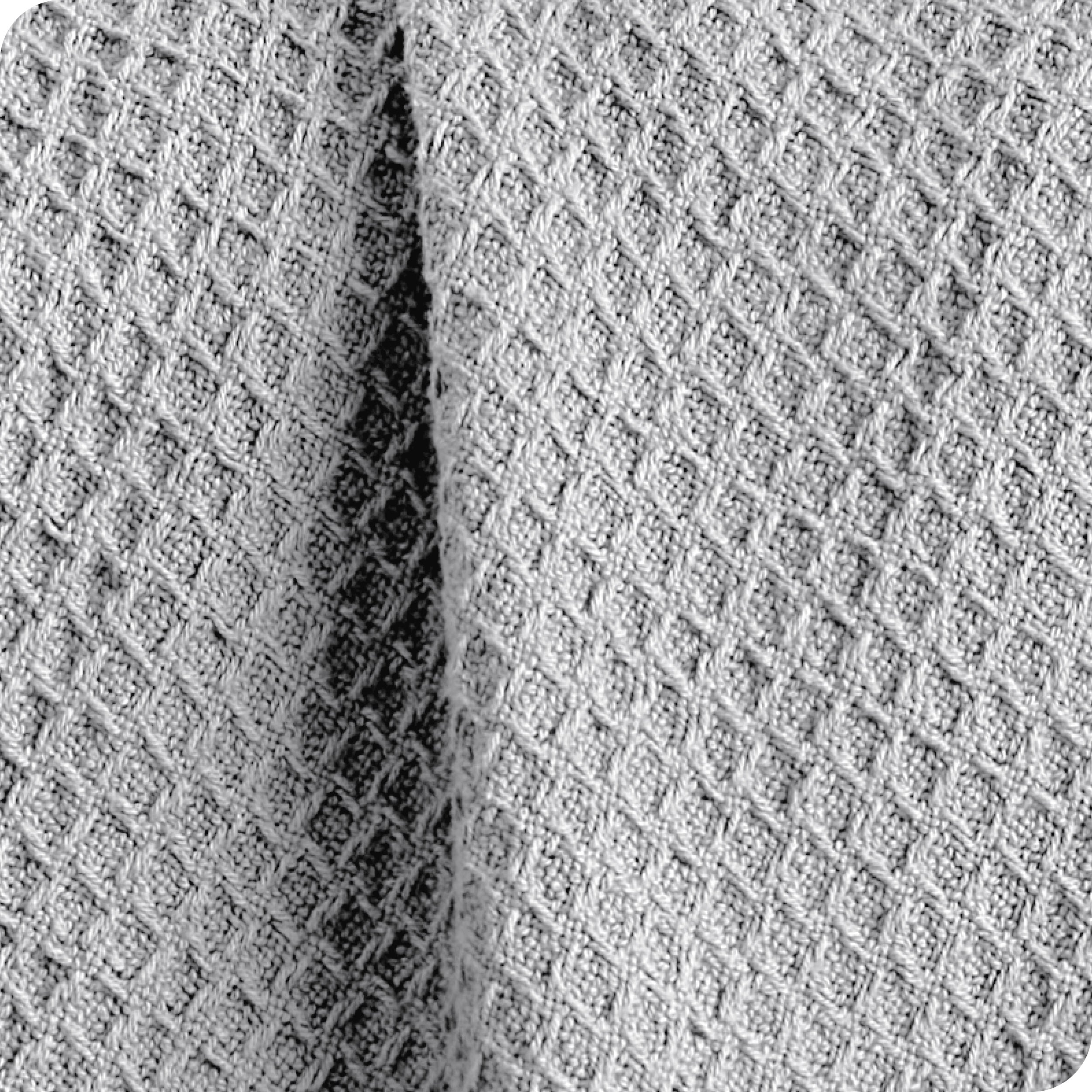Close up of the fabric of a cotton waffle blanket