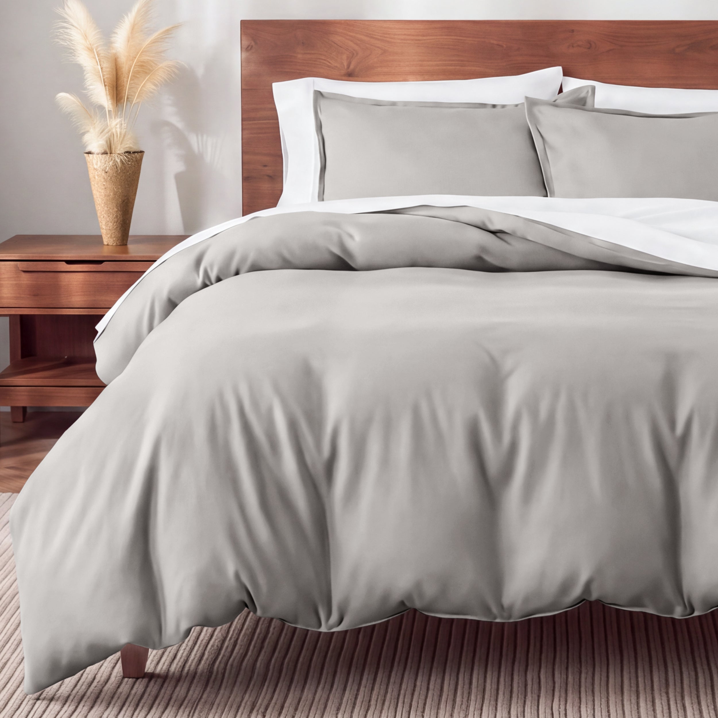 Flannel bedding set on a bed in a bedroom with a nightstand and lamp.