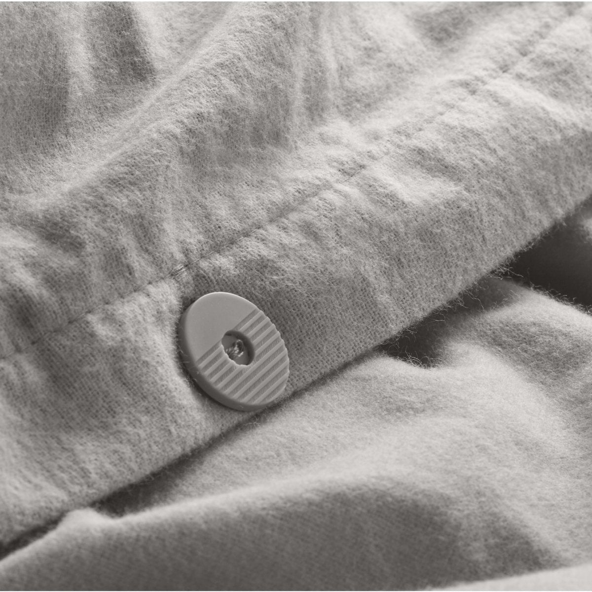 Close up of the button closure on a flannel duvet cover