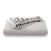 A folded flannel cotton fitted sheet in a white background