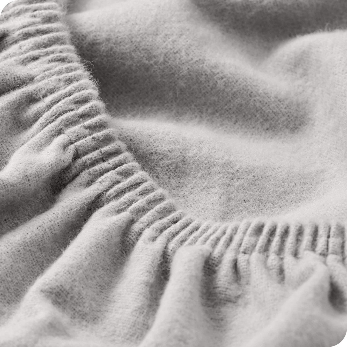 Close up of the elastic portion of a flannel fitted sheet