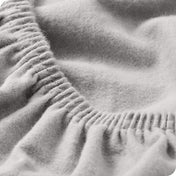 Close up of the elastic portion of a flannel fitted sheet