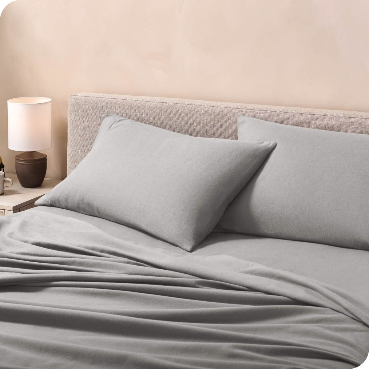 Flannel pillowcases on a mattress leaning against the headboard