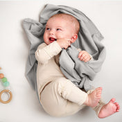 A baby lying on a flannel receiving blanket