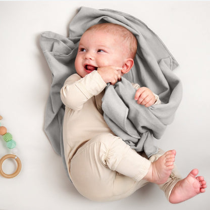 A baby lying on a flannel receiving blanket