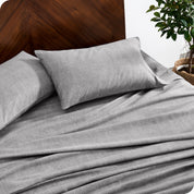 A close view of a flannel sheet set on a modern bed with two pillows.