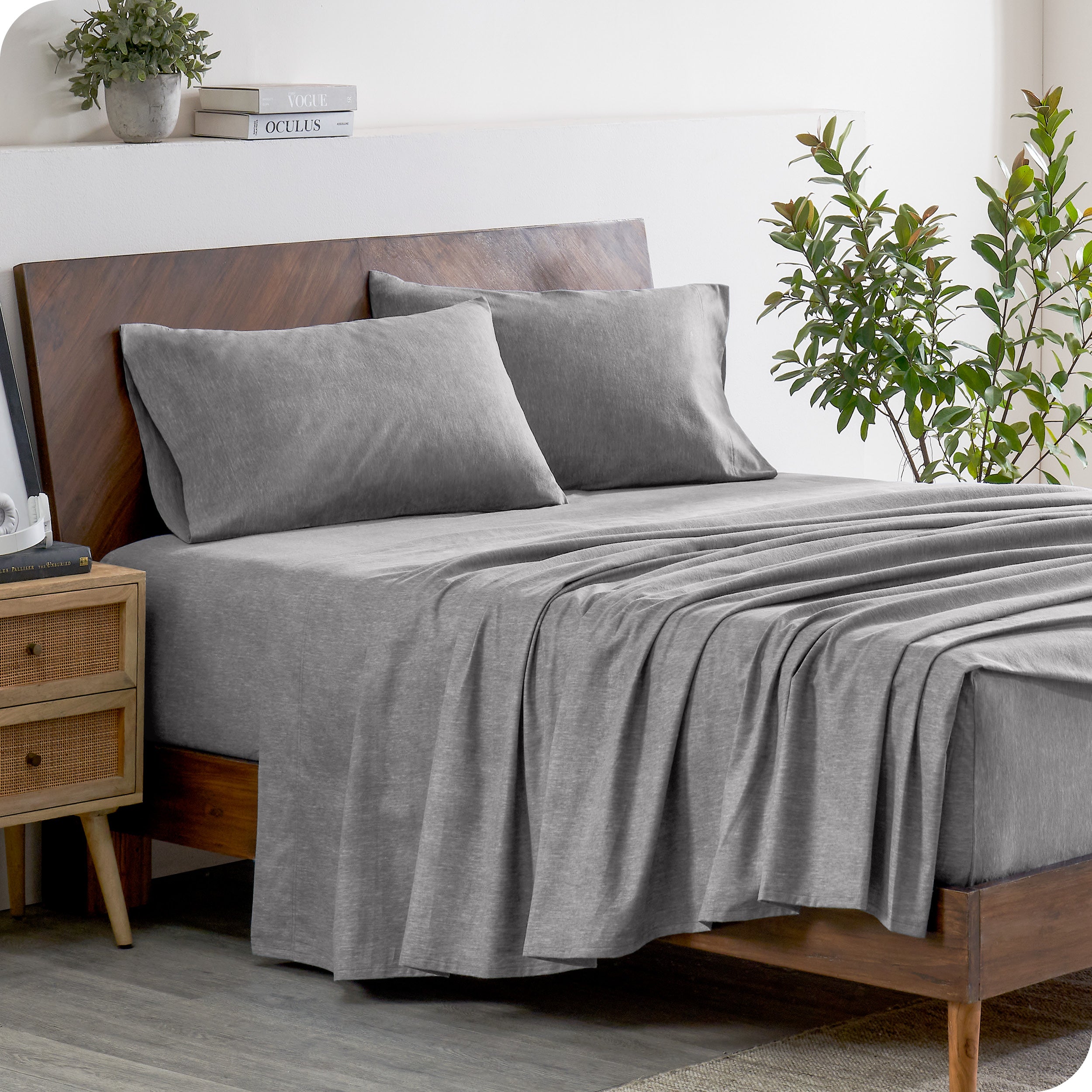 A sideview of a modern bed with a flannel sheet set.