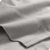 A close view of the flat top sheet showing the texture and stitching