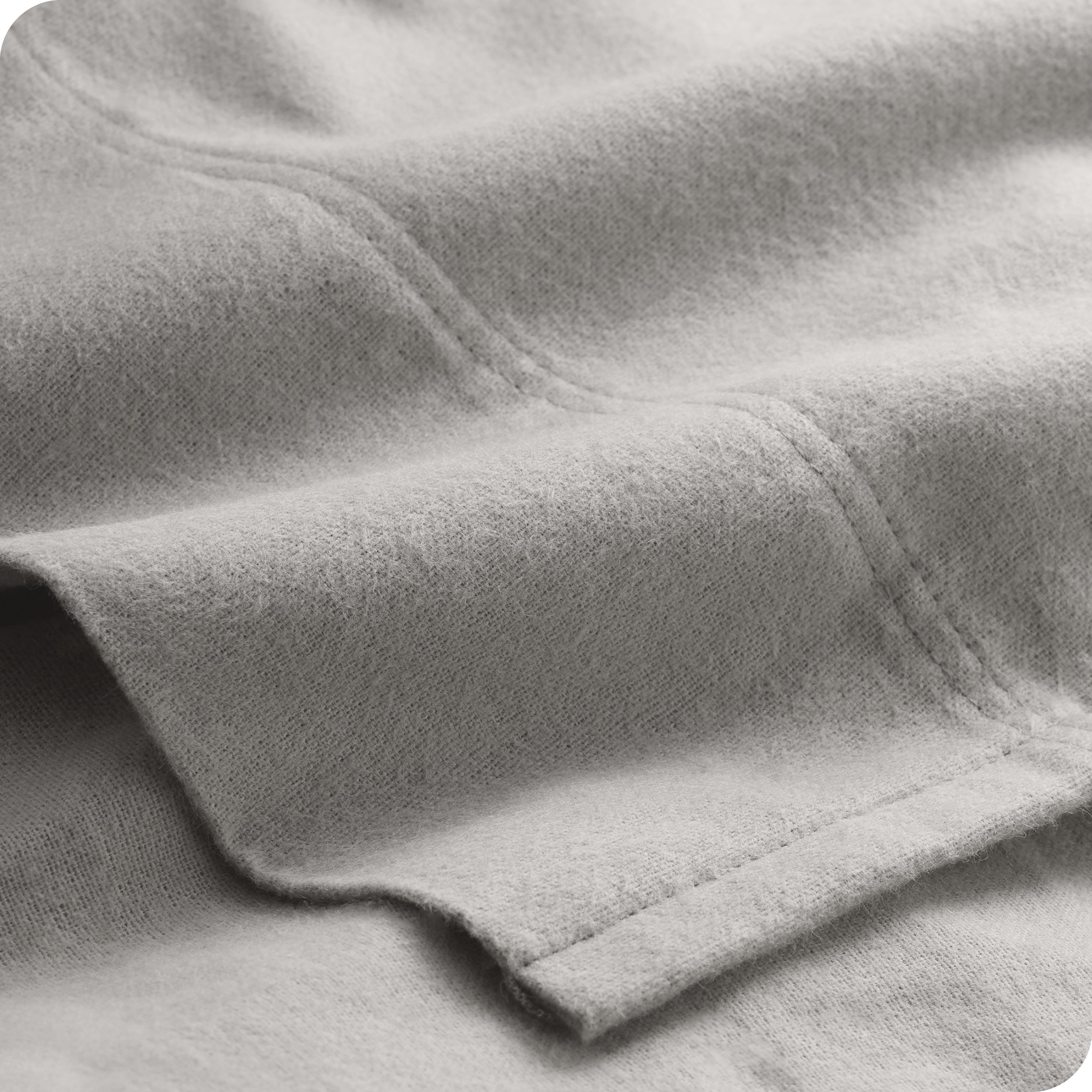 A close view of the flat top sheet showing the texture and stitching