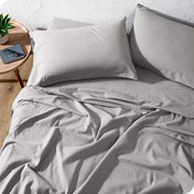 A high front view of a modern bed with a flannel sheet set on it